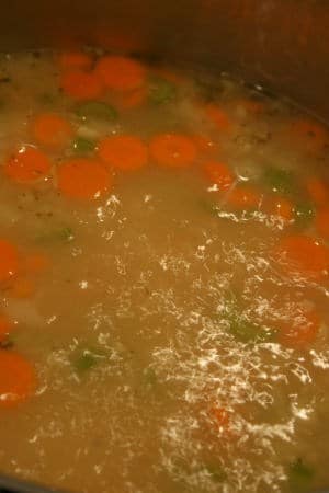 Chicken soup at a rolling boil in the pot