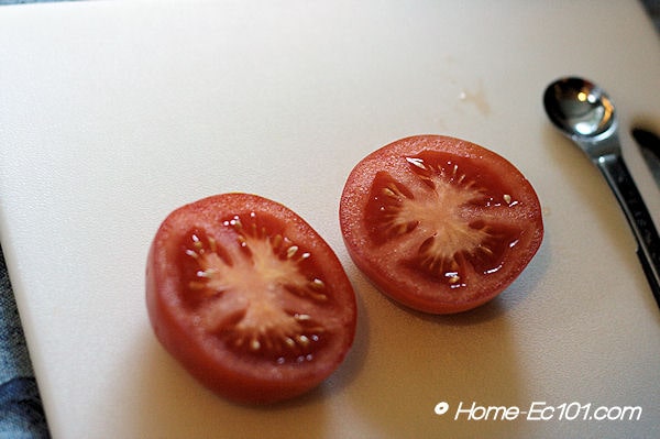 Cut the tomato in half