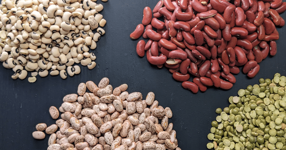 dried black eyed peas, kidney beans, split peas, and pinto beans on a black background