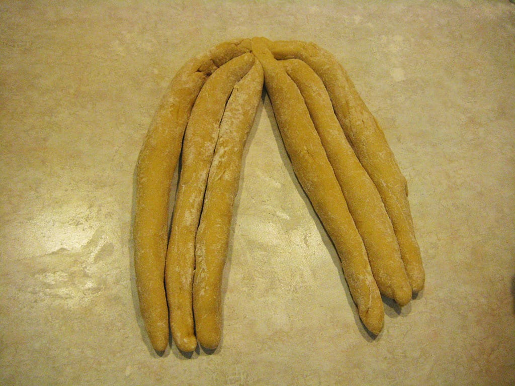 Challah dough strands split into two sections of three