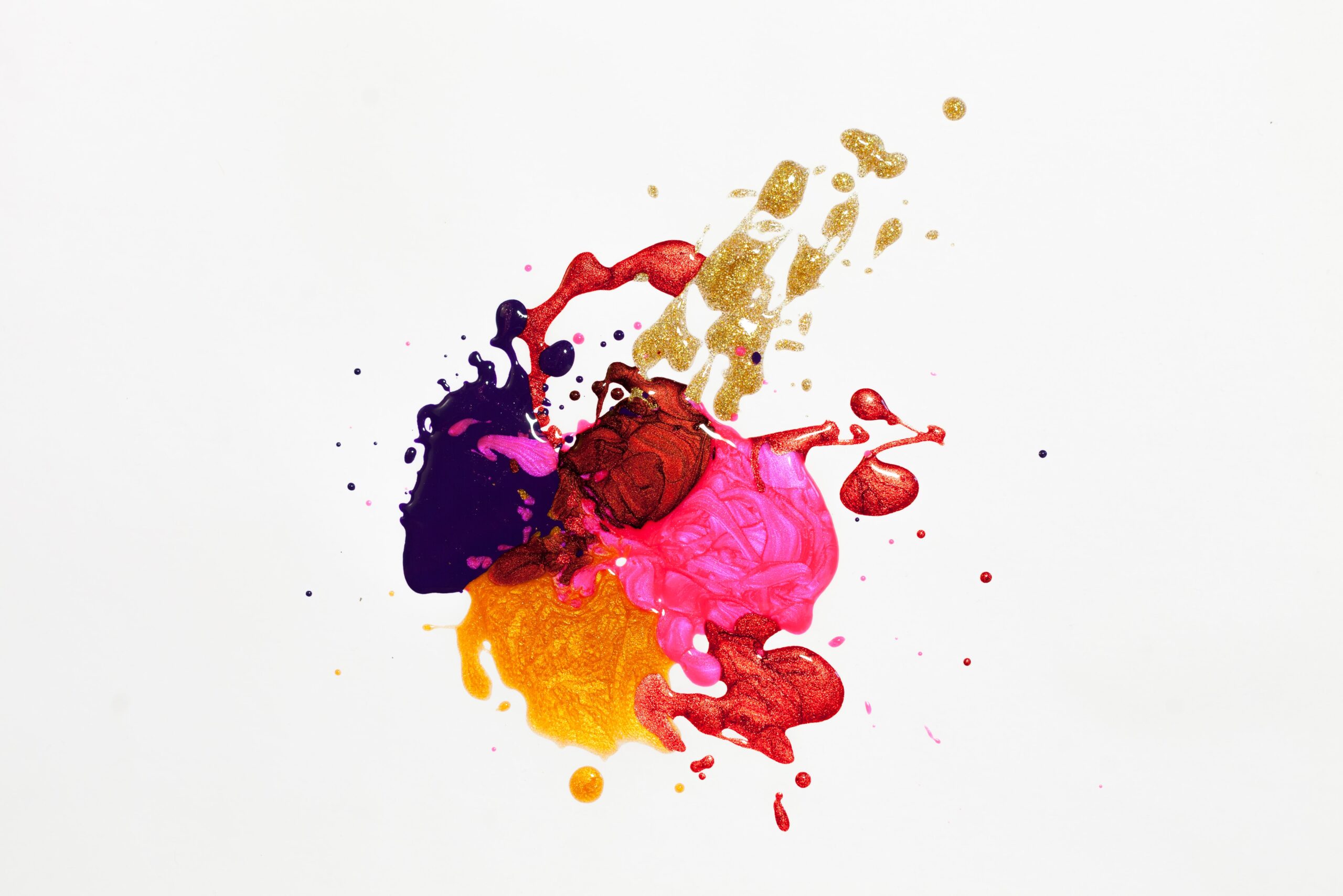 Ink blot with yellow, red, pink, blue, gold, and orange paint to look like stains