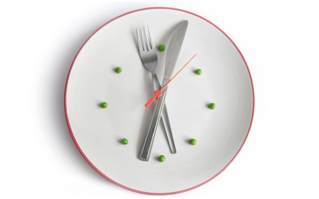 Plate with a knife and fork to represent hands on a clock with peas to represent times for meal plans or meal planning for our weekly menu series