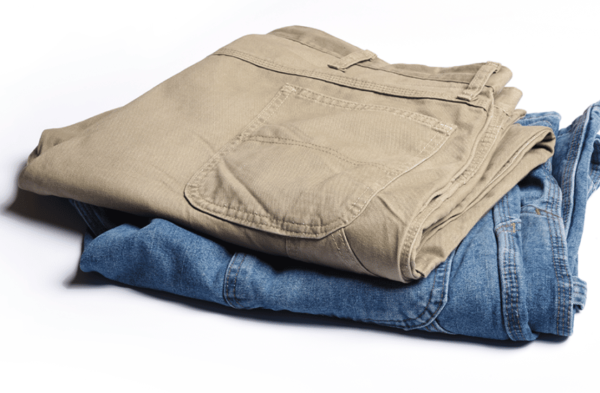 Folded khaki pants on top of folded jeans
