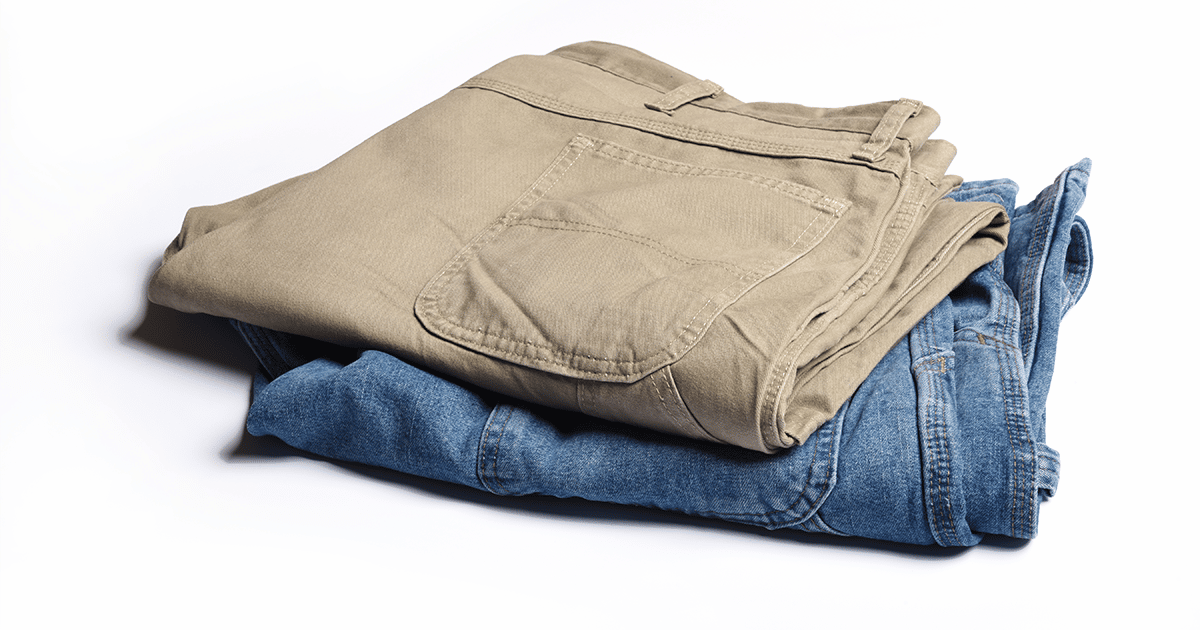 Folded khaki pants on top of folded jeans